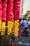 Garlands of red and yellow flowers. Flower stall selling garlands for temple and marriage functions. Selling flowers Garlands on