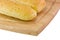 Garlic breadsticks on cutting board detail