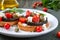 Garlic bruschetta with eggplant, feta, cherry tomatoes, capers. Useful vegetarian appetizer. Italian Cuisine