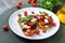 Garlic bruschetta with eggplant, feta, cherry tomatoes, capers. Useful vegetarian appetizer. Italian Cuisine