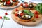 Garlic bruschetta with eggplant, feta, cherry tomatoes, capers. Useful vegetarian appetizer. Italian Cuisine