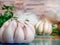 A garlic bulb Allium sativum on the kitchen table and other vegetables in the background