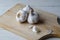 Garlic Bulbs on Chopping Board - Angled Elevated View