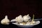 Garlic Bulbs and Cloves on White Plate with Knife