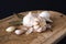 Garlic bulbs on wooden board, on black background. Natural antibiotic. Growing vegetables home, farming.