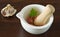 Garlic and celery leaf ready for mashing in a mortar and pestle