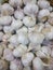 Garlic on the counter of the vegetable market. Close-up and top view of fresh vegetables on store shelves. Ingredients for salads