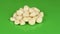 Garlic on green background. Side view. Loop motion. Rotation 360.