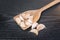 Garlic herb whole cloves in wooden spoons over wooden table