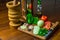 Garlic, onions, green peppers, tomatoes and parsley and chives on wooden cutting board with glass of olive oil, salt and peppers