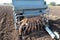 Garlic sowing by tractor, the process of planting garlic cloves in the field. The concept of spring or autumn farming