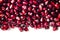 Garnet fruit seeds wallpaper. Pomegranate seeds natural background. Tropical fruit pattern