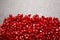 Garnet seeds on a stone background. Top view of red pomegranate seeds on a table. Agricultural background. Copy space.