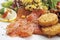 Garnished smoked salmon with motley salad and potato patties, served on plate