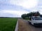 Garut, Indonesia- December 12,2022 :Beautiful landscape growing Paddy rice field two side with long road and mountain