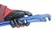 Gas adjustable wrench in a man`s hand in a red working glove. Locksmith tool