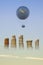 Gas Balloon, Stakes of Coins and Yellow Aircraft against the Sky