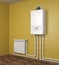Gas boiler and heater radiator with pipelines on orange wall in house. Heating system