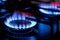 Gas burner with blue burnig methane flame on dark background