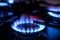 Gas burner with burnig methane on dark background