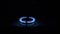 Gas Burner On, Glowing with Blue Flame, at Night in Kitchen. Close-up