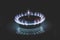 Gas burner on stove. Selective focus. Blue propane gas burns on the kitchen gas stove. consumer natural gas