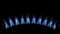 Gas burns blue, Heat and Mirage above the gas hob switched on. Top view of a kitchen burner glowing at night, close-up