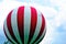 gas filled isolated red and white striped adventure balloon hovering over Budapest. closeup view