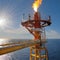 The gas flare on the offshore oil rig platform. Gas flare boom at an oil refinery. Concept of environment, pollution and global