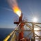 The gas flare on the offshore oil rig platform. Gas flare boom at an oil refinery. Concept of environment, pollution and global