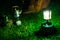 Gas lamp and hiking boots  on green lawn. Blurred Aluminum Kettle on gas camping stove on the back.Camping in nature.shallow focus