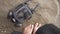 A gas mask lies on a stone against the background of women's feet on the beach by the sea