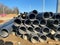 Gas polypropylene pipe in rolls on the street, black plastic pipes