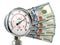 Gas pression gauge meter with dollar banknotes. Gas price and heating costs payment concept