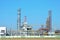 Gas Processing Plant. Power pipes and industrial refinery towers of the natural gas factory on the background blue sky