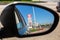 Gas station Lukoil price sign reflection in the rearview mirror