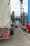 Gas station worker refueling a car with a trailer