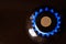 gas stove burner with one euro coin laid on top, burning natural gas with blue flame