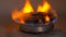 Gas stove with burning orange and blue fire on it