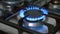 Gas stove turns on with burning blue gas flame