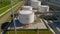Gas tanks with pipeline system at refinery complex aerial