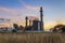 Gas turbine electrical power plant at dusk with blue sky