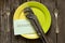 The gas wrench lies in a green plate and a sheet of paper with the word repair in English on the table next to a spoon on a wooden
