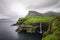 Gasadalur village and its iconic waterfall, Vagar, Faroe Islands, Denmark. Long exposure.