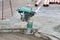 Gasoline or diesel vibratory plate compactor at road construction site