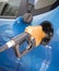 Gasoline nozzle filling up a car