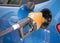 Gasoline nozzle filling up a car