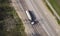 Gasoline truck Oil trailer on highway driving along the road. Tank vehicle at work aerial view above