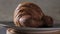 Gastronomic session of bakery, pastry. a croissant spins in the foreground, next to another croissant and other pastries