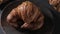 Gastronomic session of bakery, pastry. a croissant spins in the foreground, next to another croissant and other pastries